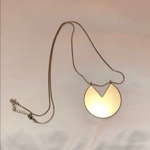 Gold circle with triangle cut out long necklace